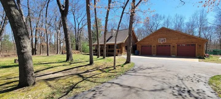 Log home and three-car garage tucked in the oaks