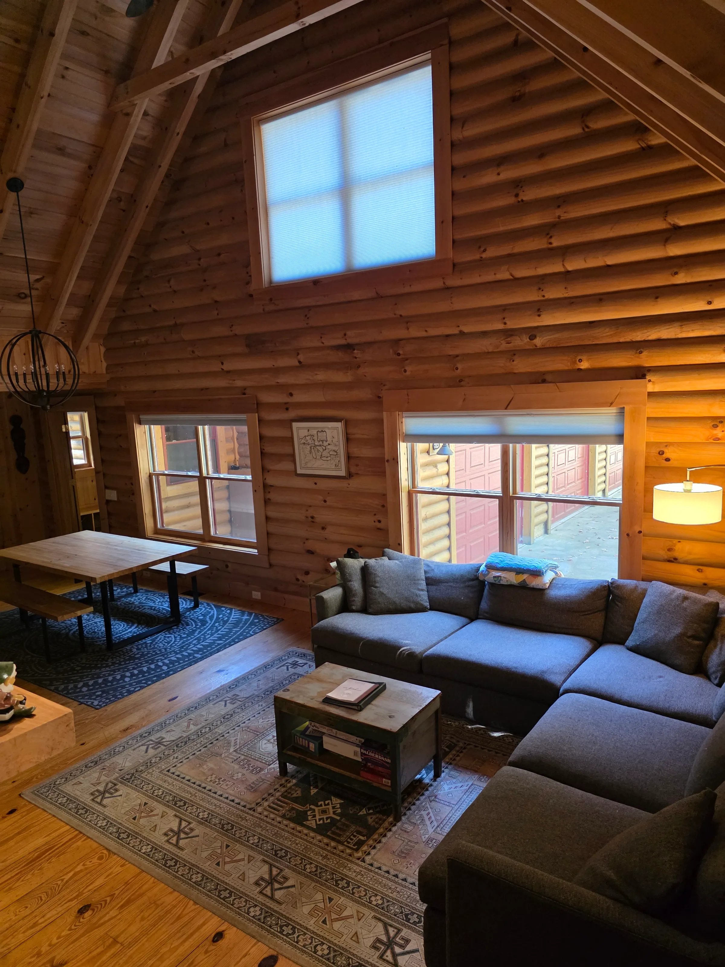 Great room with a big sectional and dining table