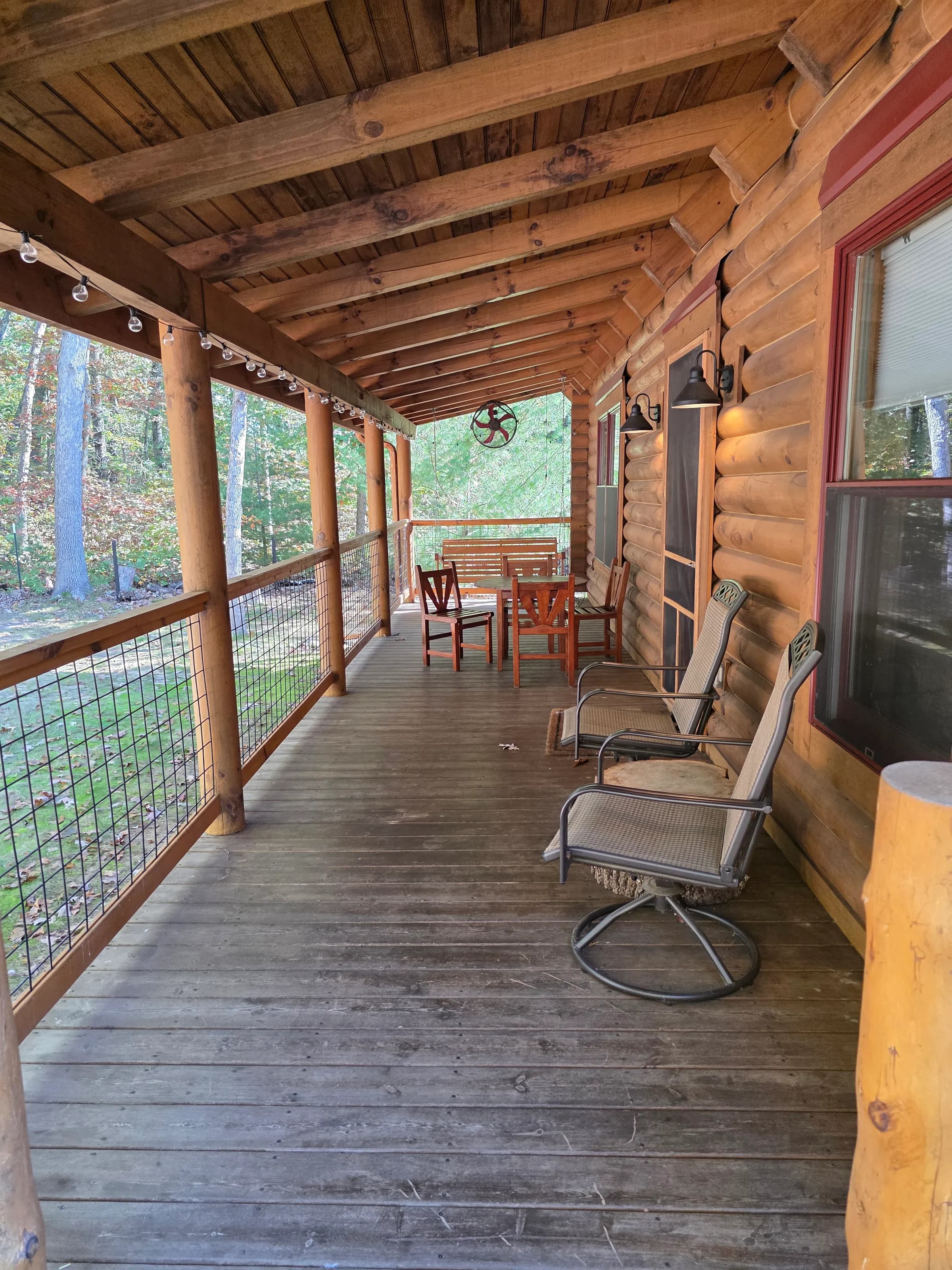 Covered front porch with seating and a dining table